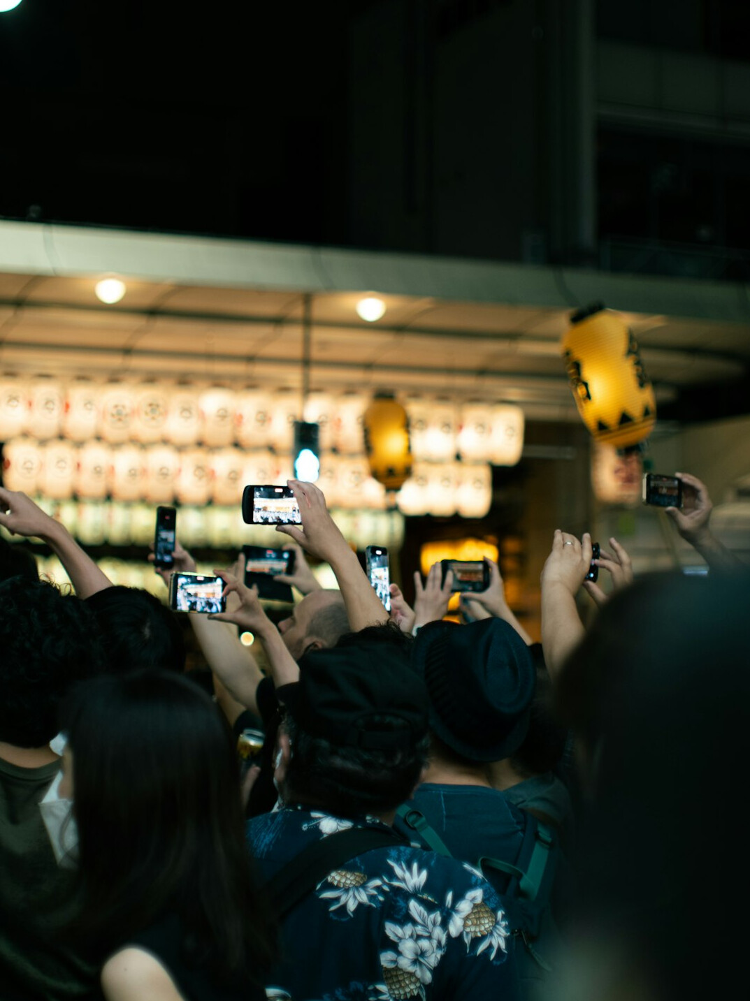 Crowd of young people recording a live event on smartphones